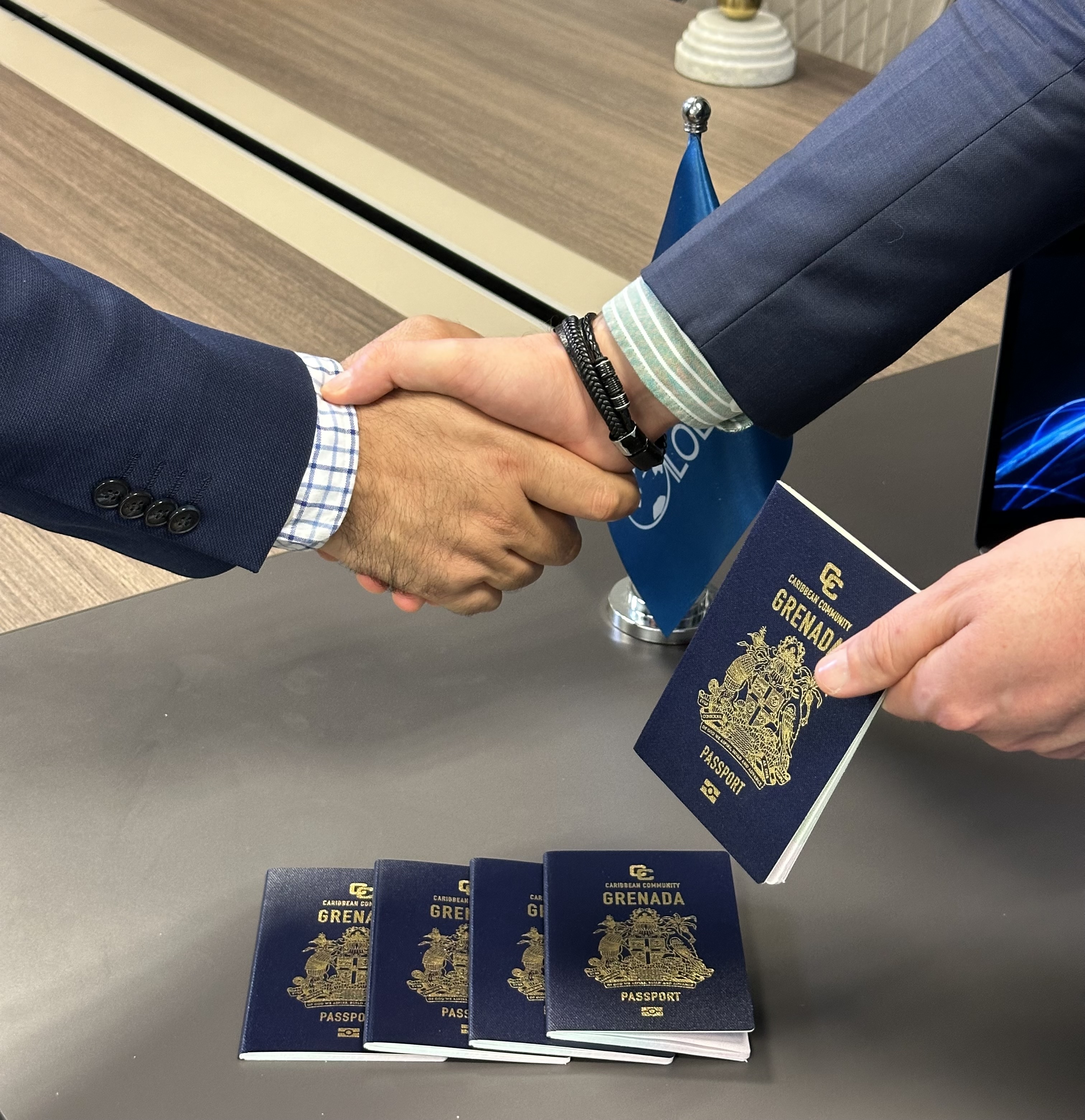 Professional handshake with Grenada citizenship by investment passports - Globevisa Group Partner Referral Program success